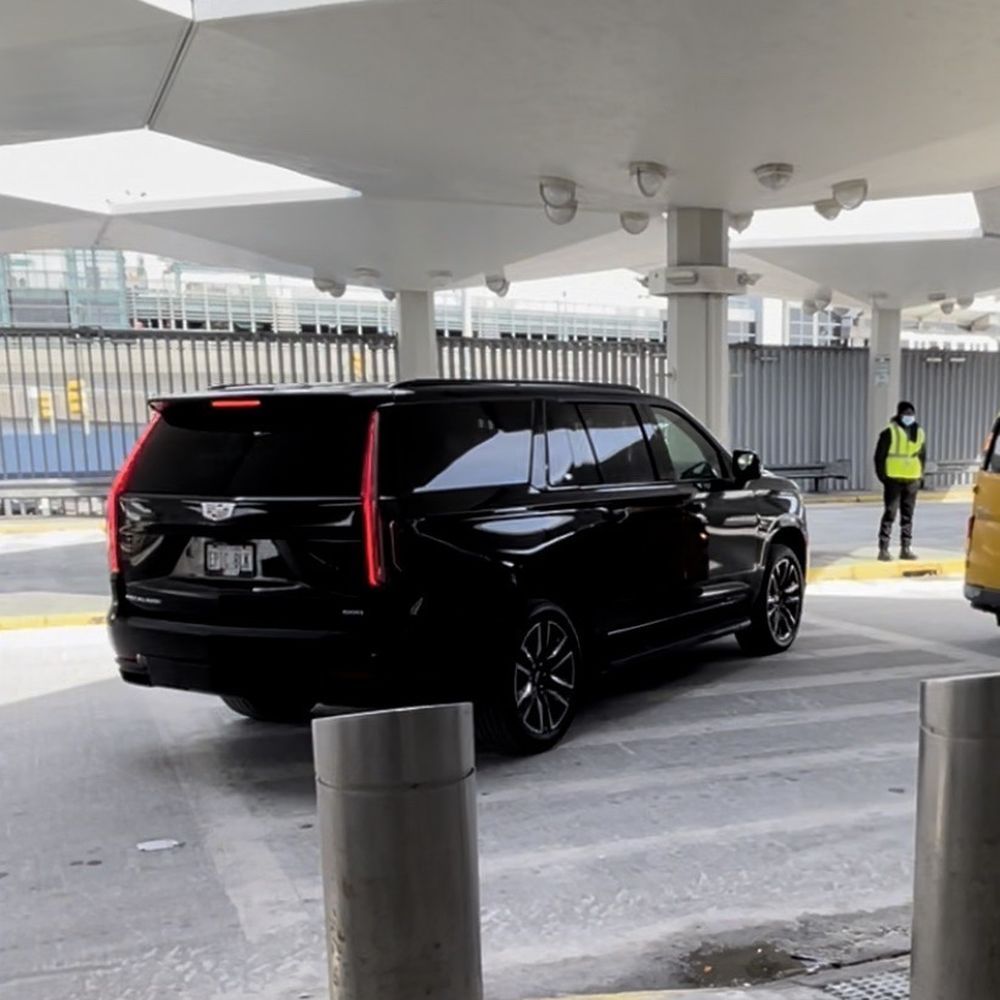 A black suv is parked in a parking lot