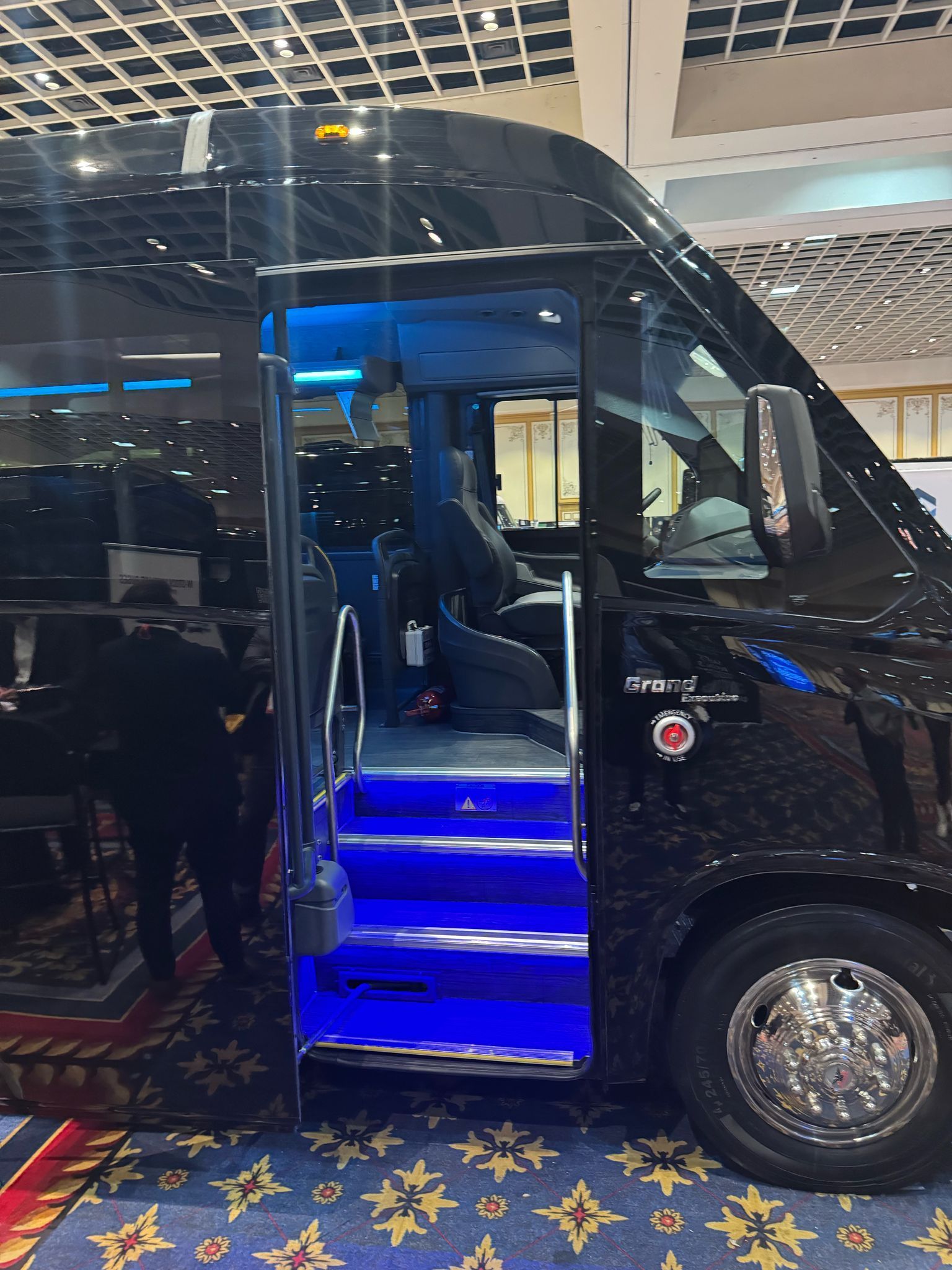 A black van with blue lights on the stairs