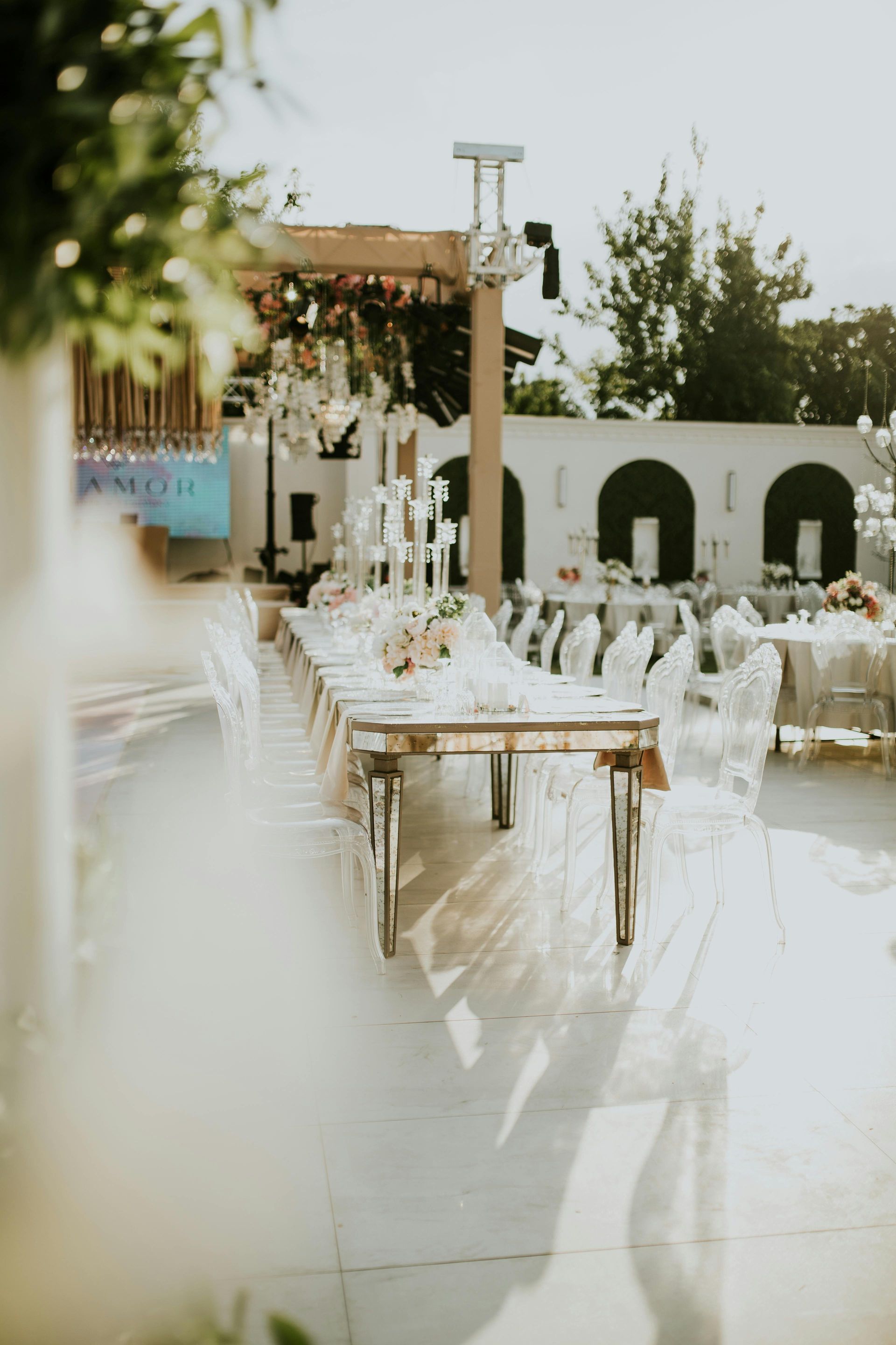 A long table and chairs are set up for a wedding reception.