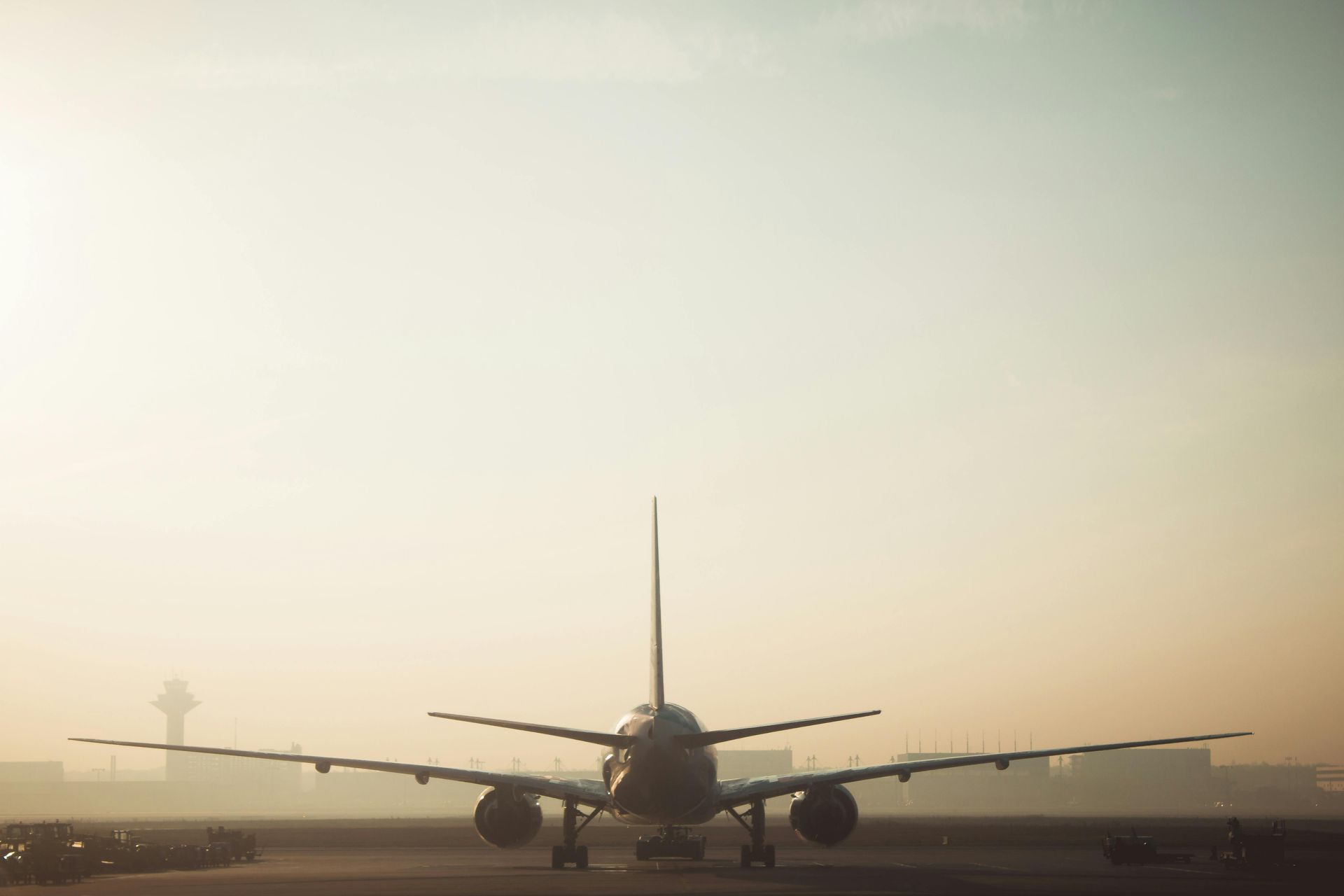 A large passenger jet is sitting on top of an airport runway.