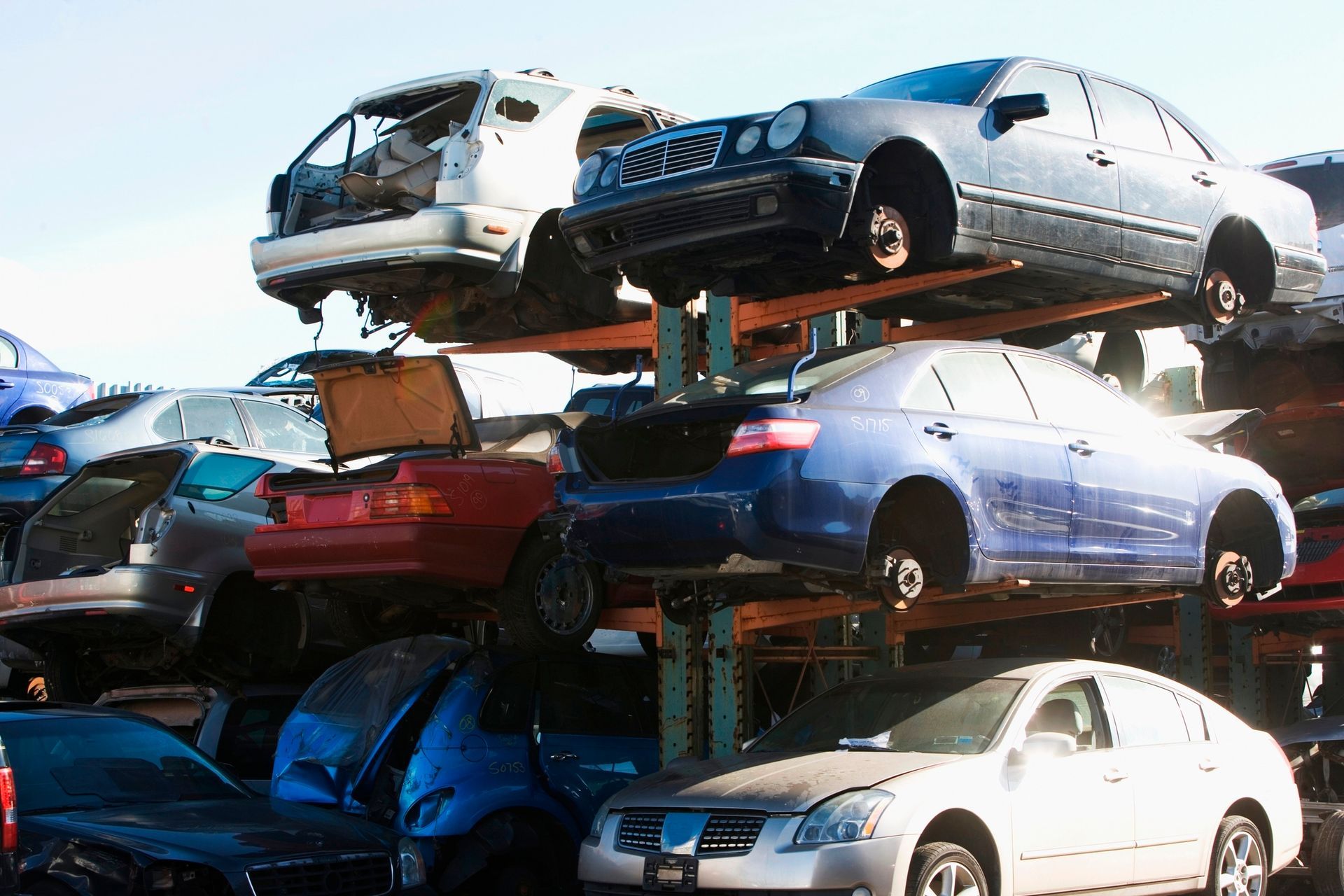 Rows of salvage vehicles awaiting parts recycling or vehicle rebuilding.