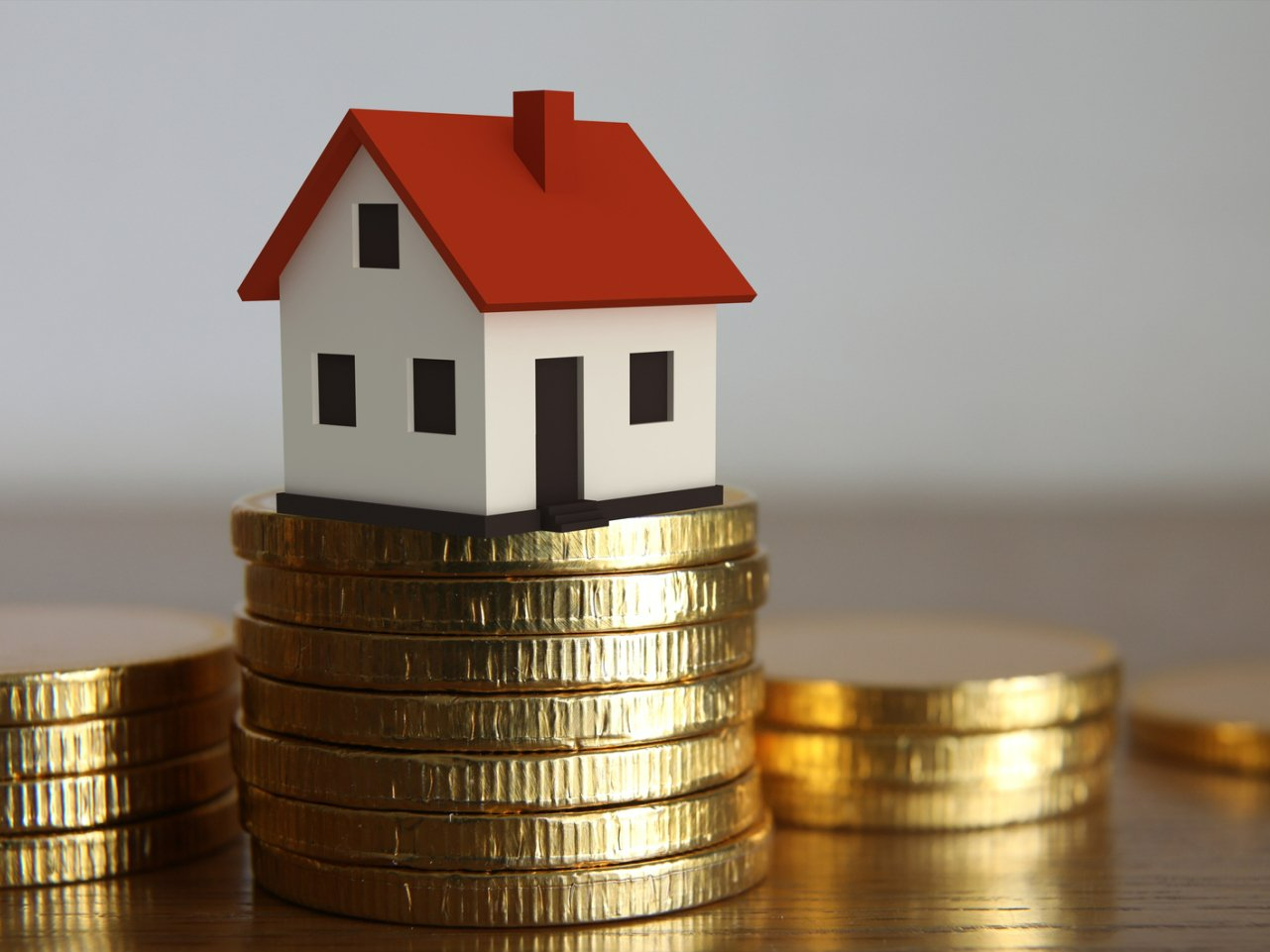 Toy house on top of coins
