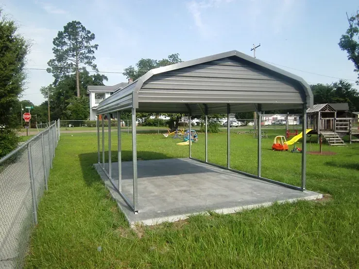 a black chevy truck is parked under a carport