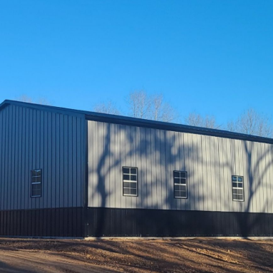 A window with a red frame is on a gray wall.