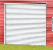 A red barn with a white garage door and a window.