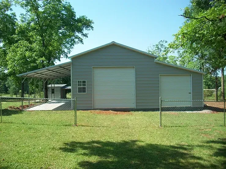 a garage with a canopy and a fence around it