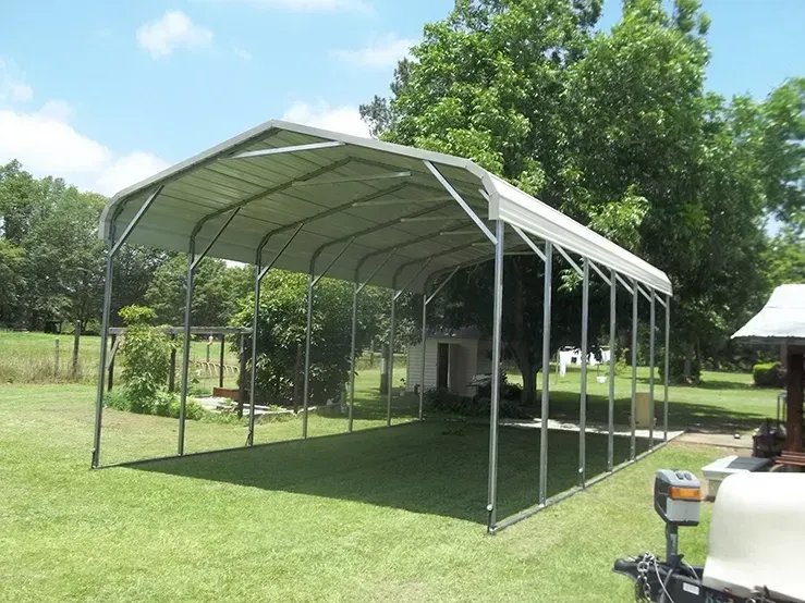 a carport is sitting in the middle of a lush green field