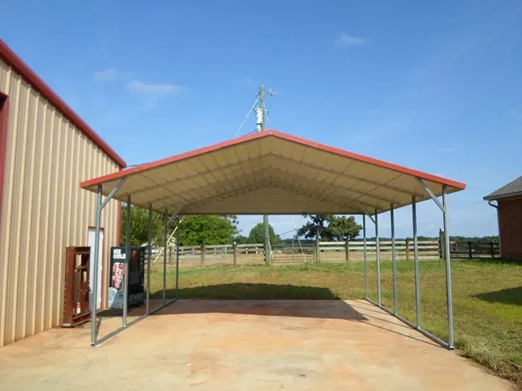 a carport with a red roof and a fence in the background