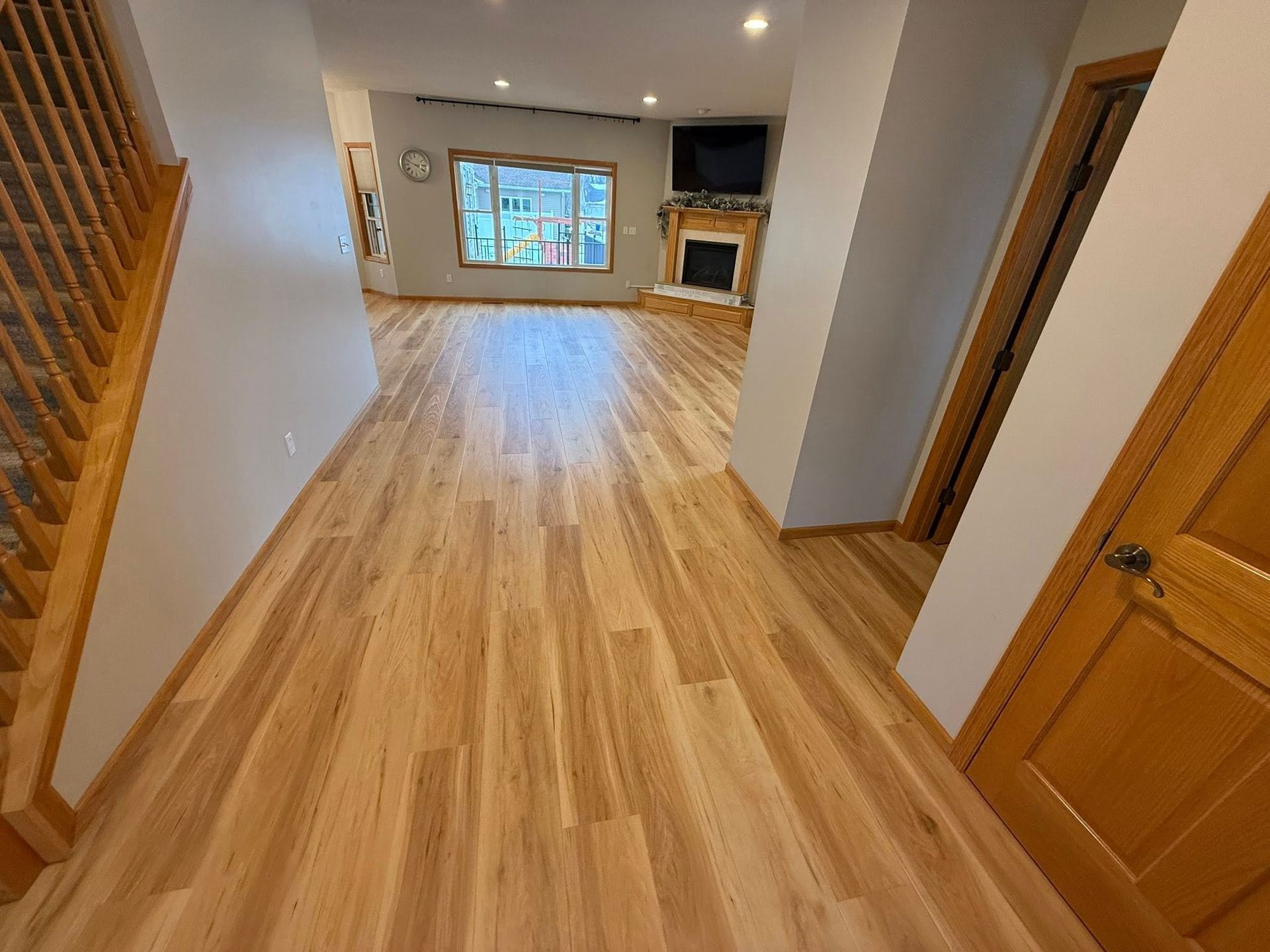 Kitchen with wood cabinets, stainless steel appliances, granite countertops, and wood floors.