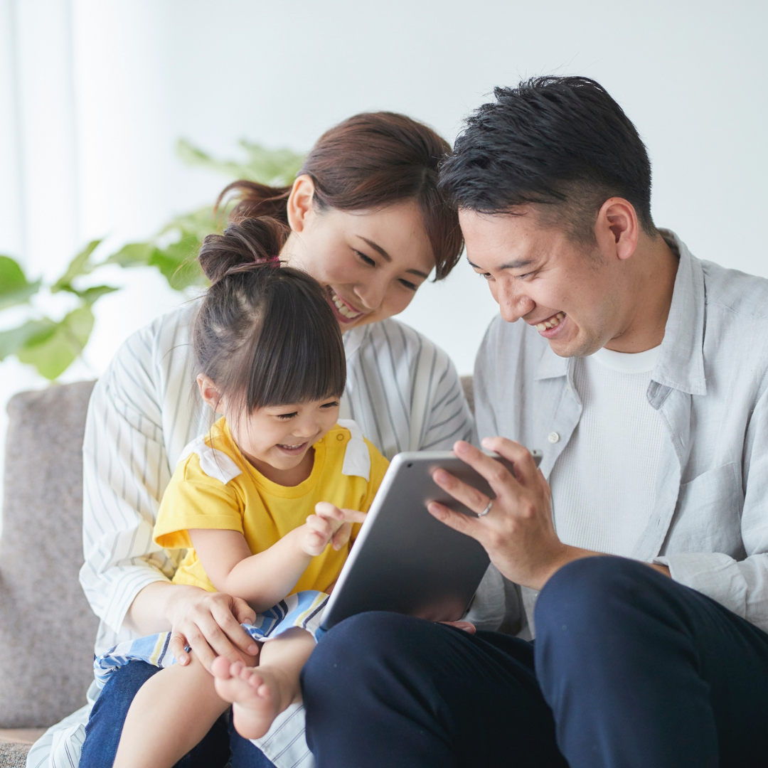 Mom and dad with child reading a book after school.