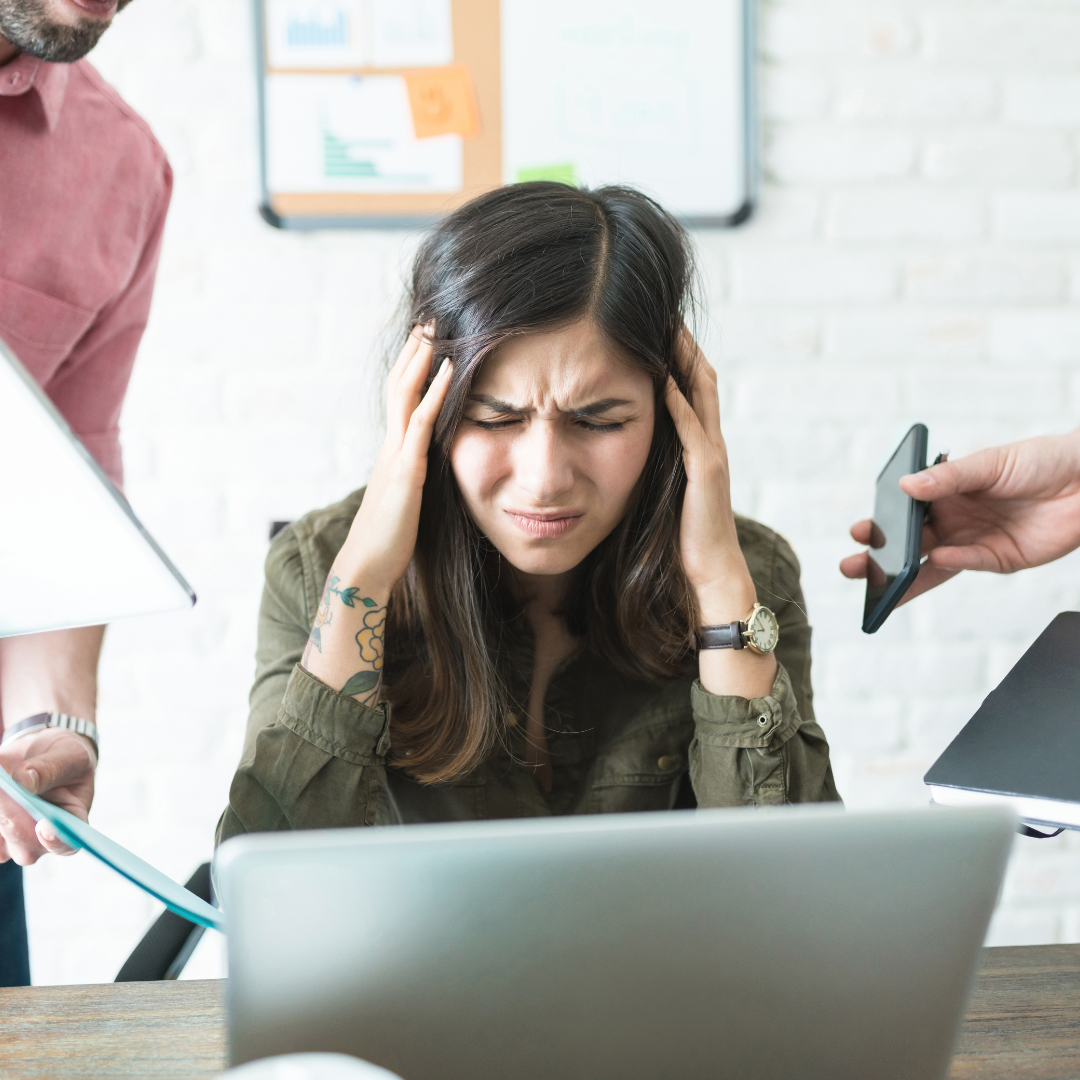 Woman at work frustrated dealing with people and demands.
