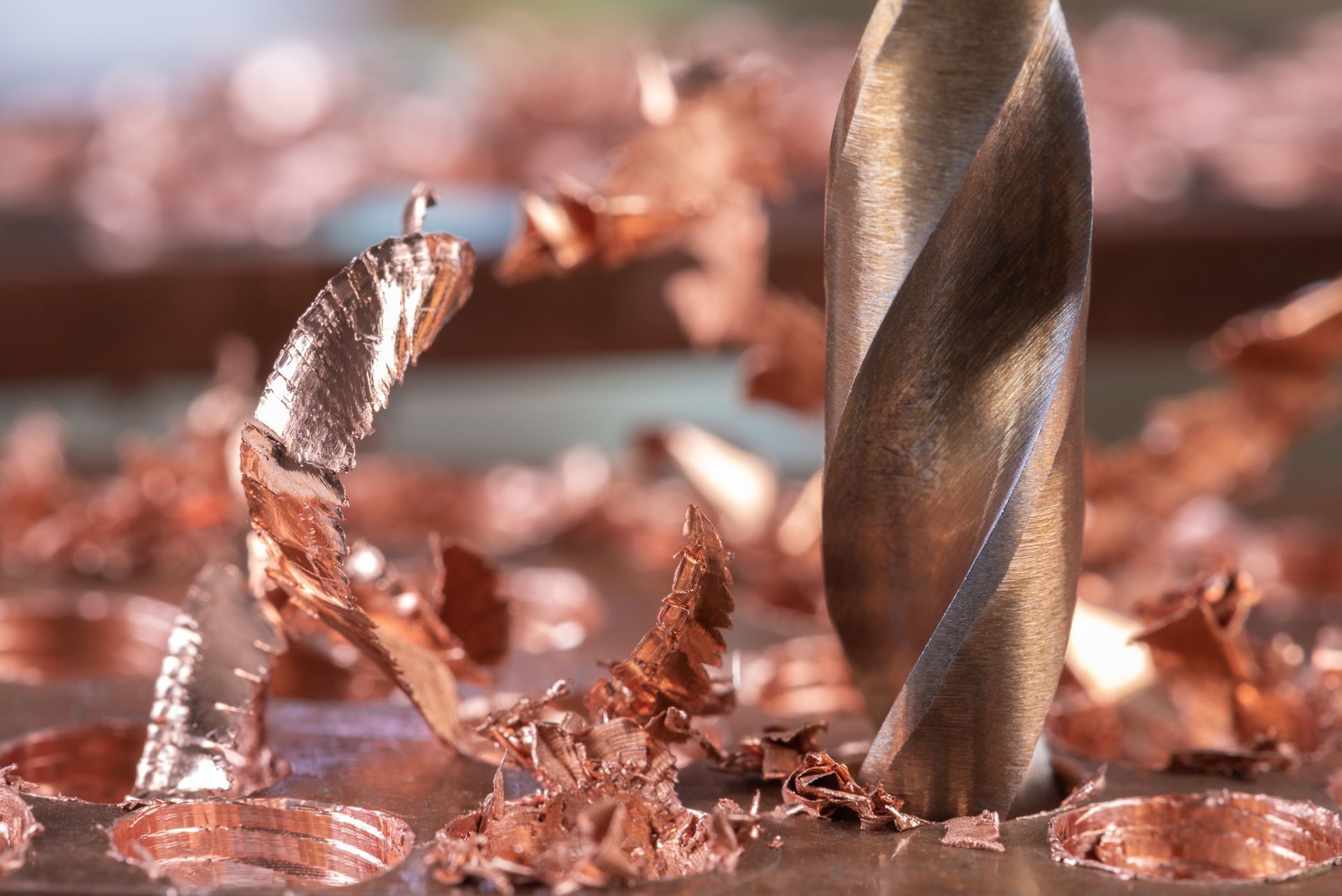 Close-up of metal copper being drilled with shavings. Close-up of metal copper being drilled with shavings.