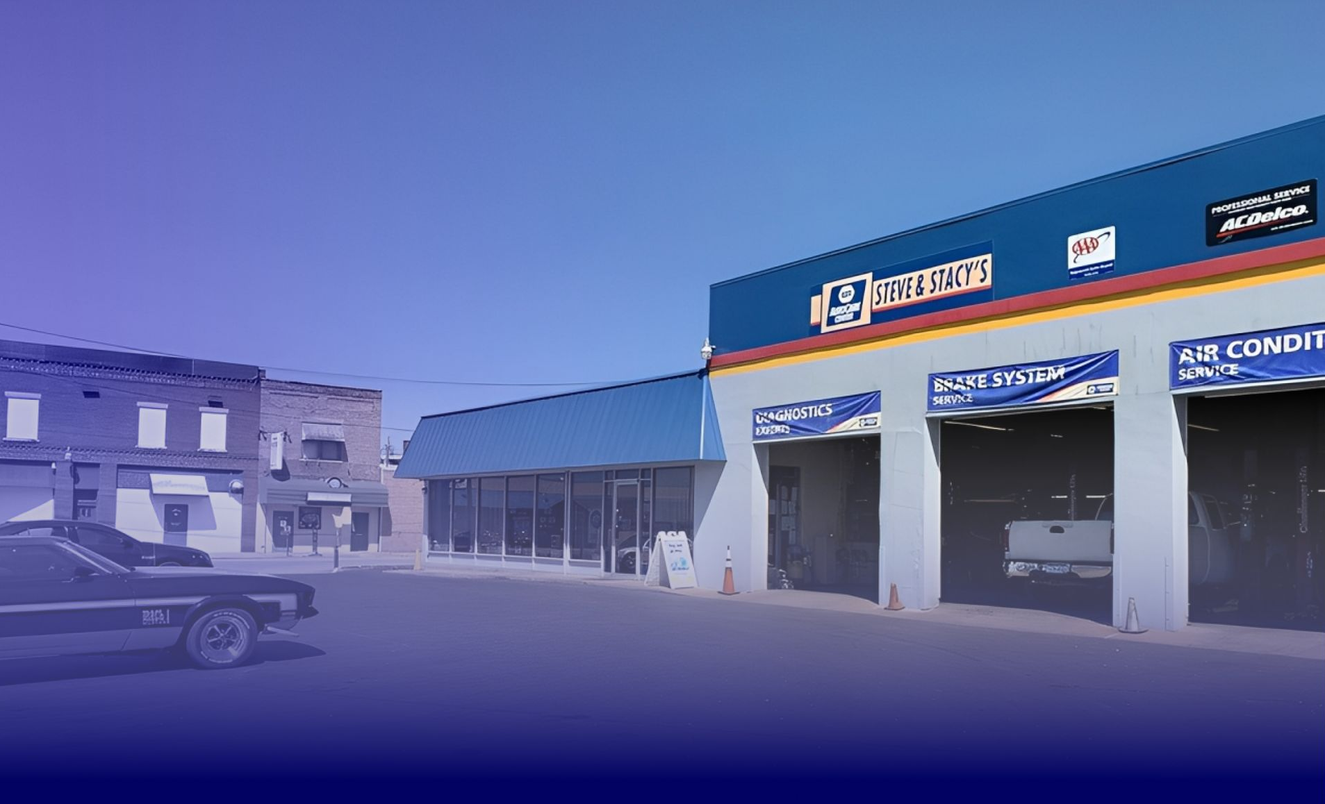 Auto repair shop with blue and white facade; car parked in front. | Steve & Stacy's Servicenter