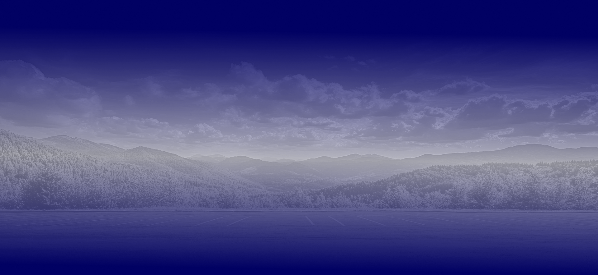 Landscape with mountains, water, and cloudy sky in shades of blue and white. | Steve & Stacy's Servicenter