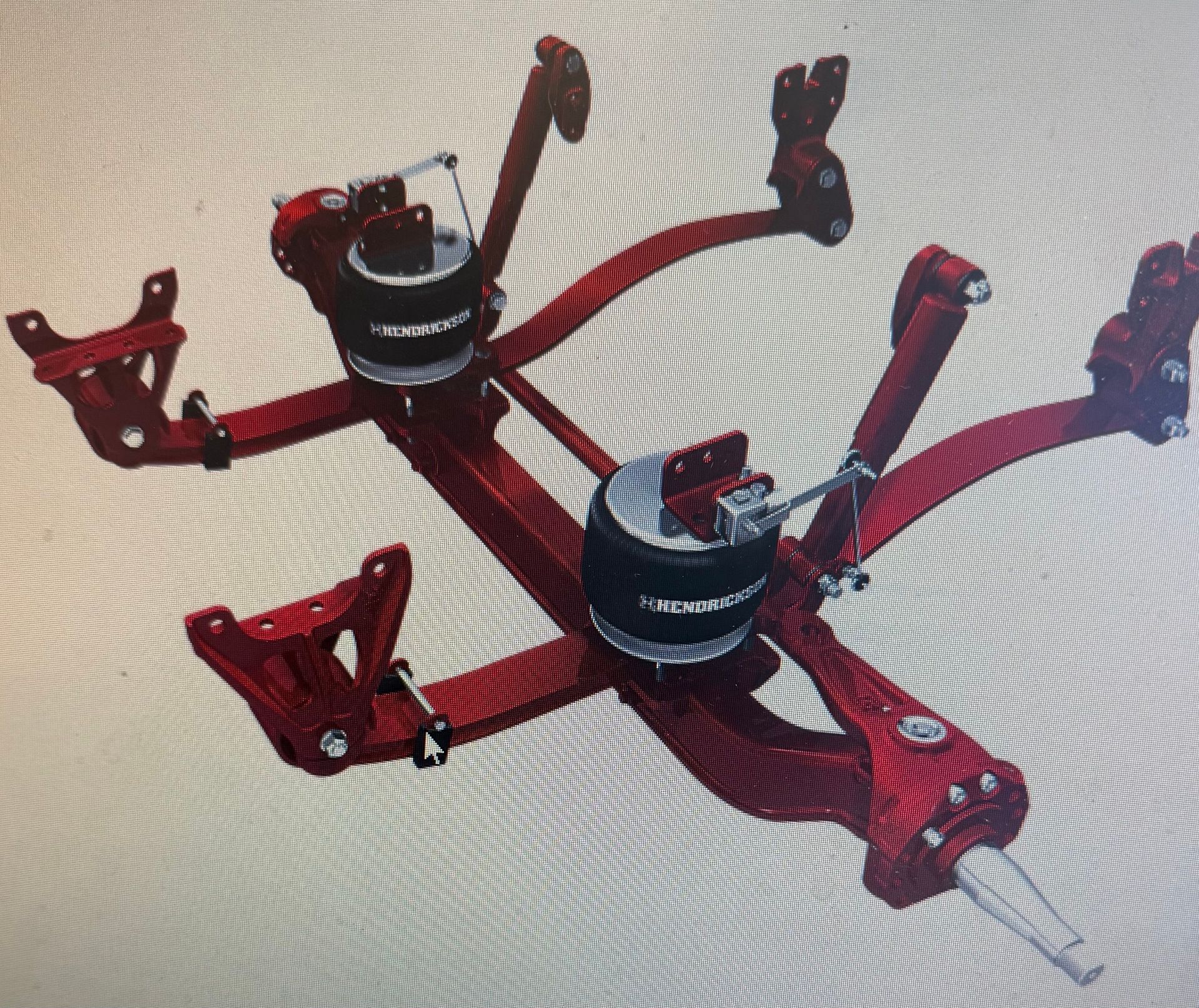 Red vehicle suspension system with air springs, designed for use on an axle.