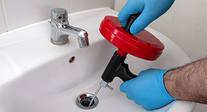 Plumber cleaning drain with auger| Drain cleaning in Stockbridge, Drain cleaning services in GA