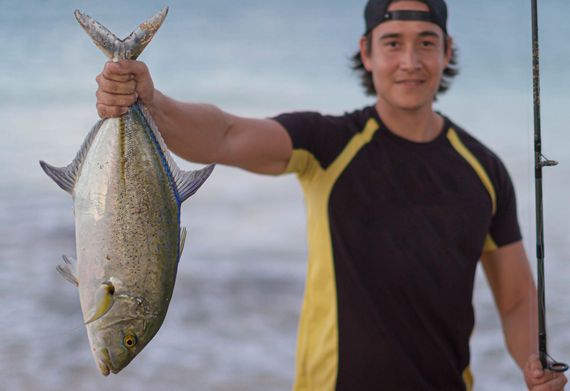 Man Holding Big Fish — Wailuku, HI — New Maui Fishing Supply