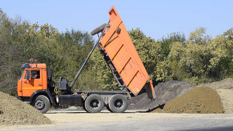 dump truck moving down sand