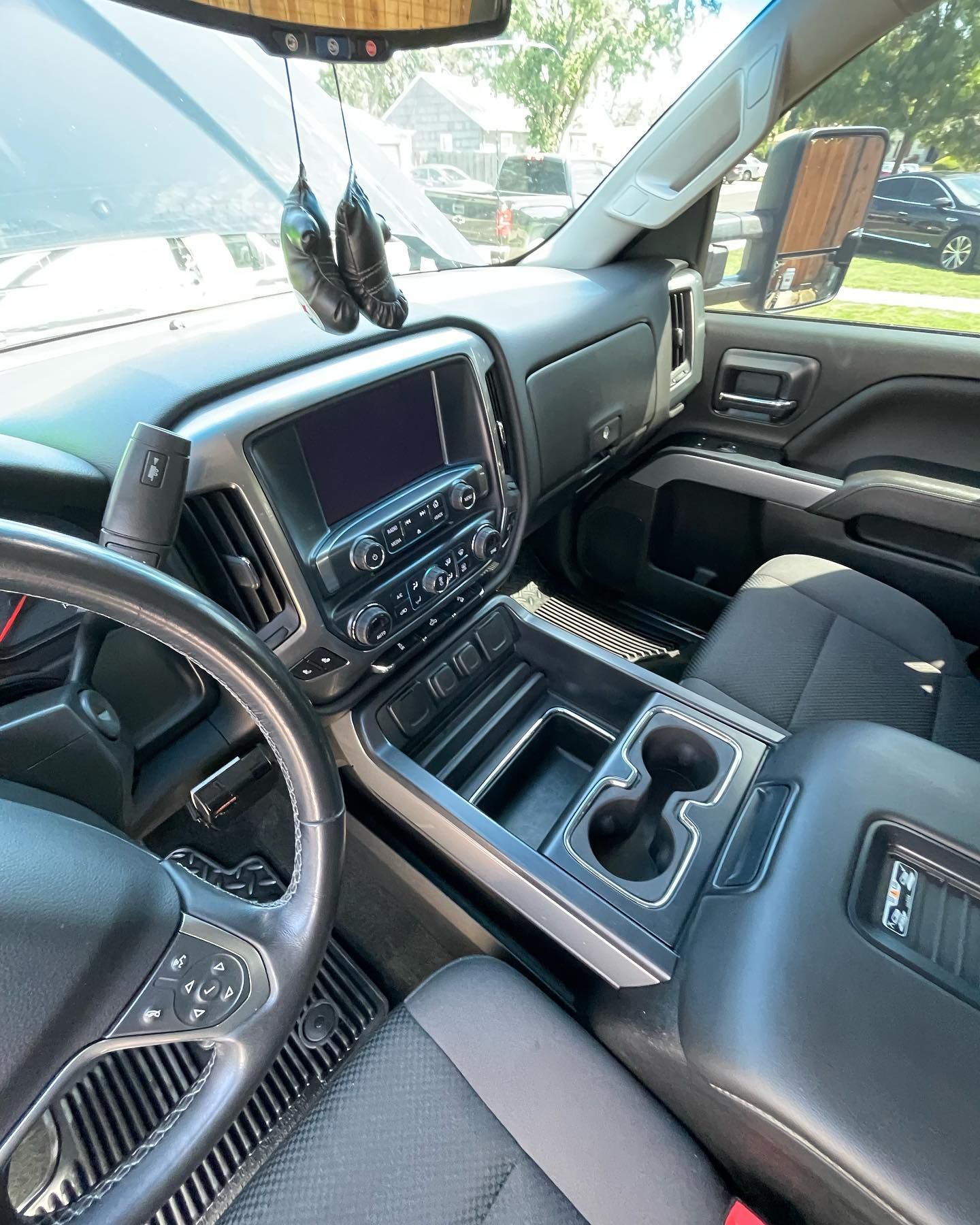 The interior of a truck with a steering wheel and a dashboard.