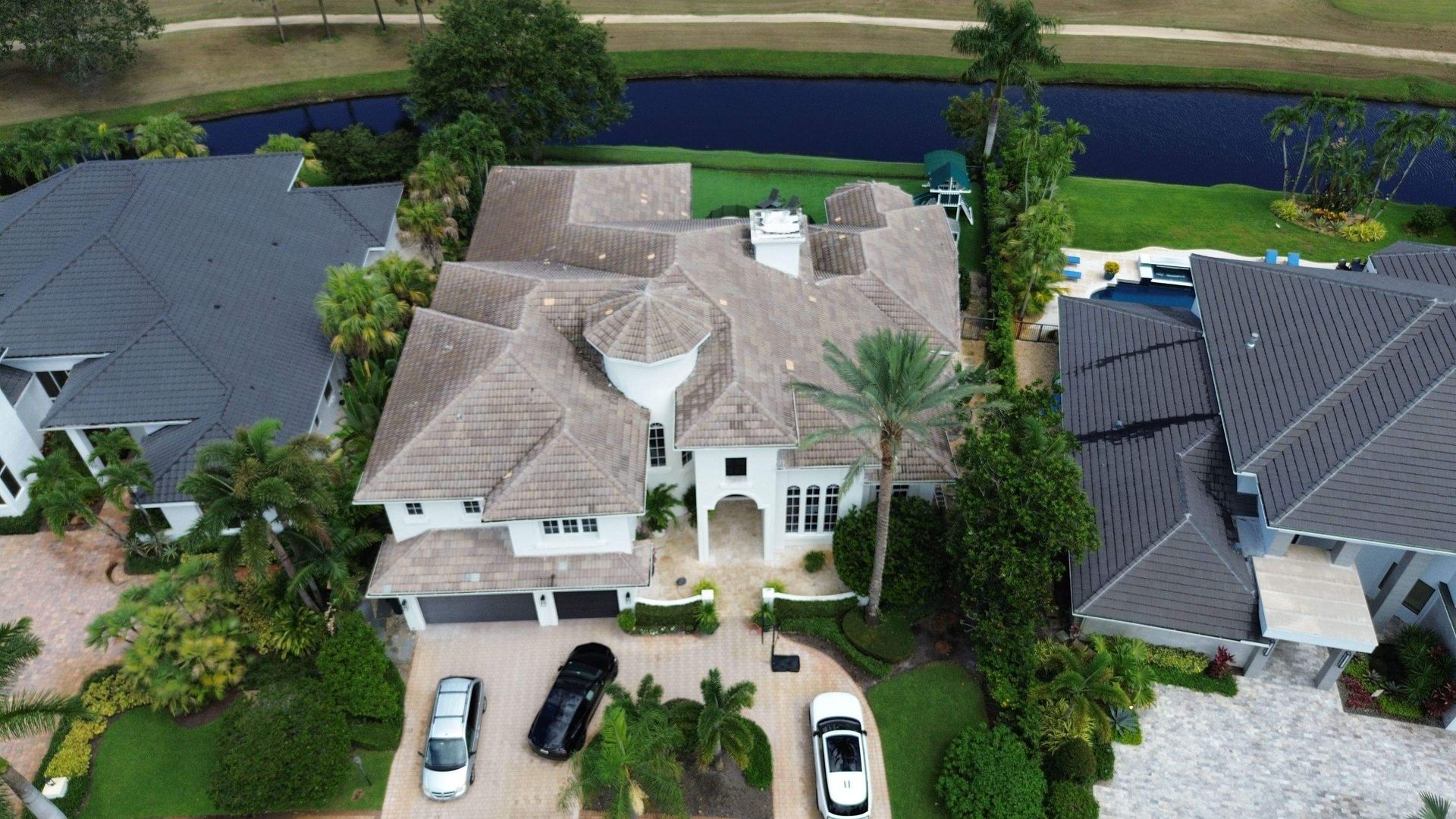 Aging tile roof with cracked and discolored tiles before roof residential replacement in Boca Raton Florida.