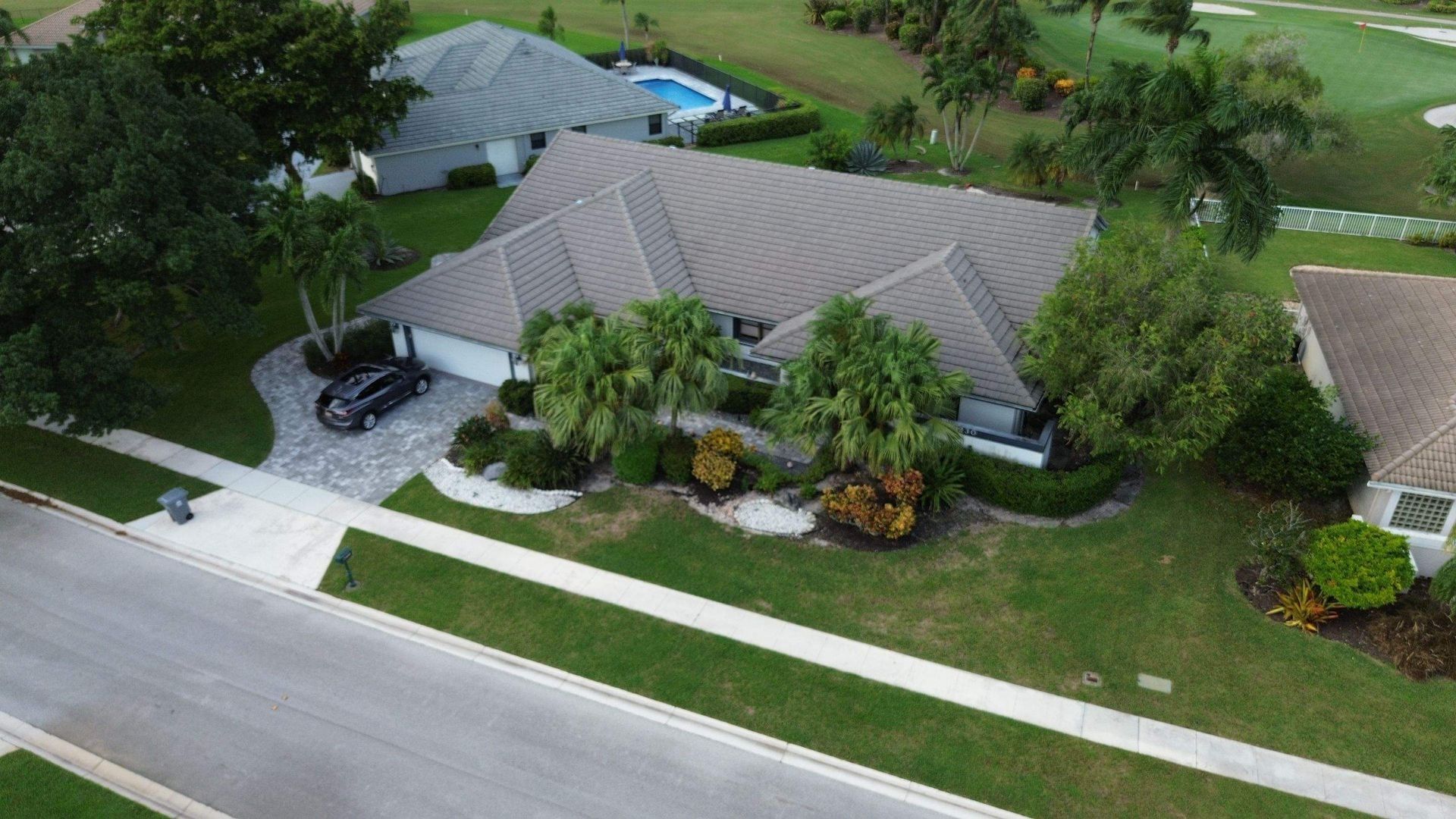 Aging tile roof with cracked and discolored tiles before replacement in Florida