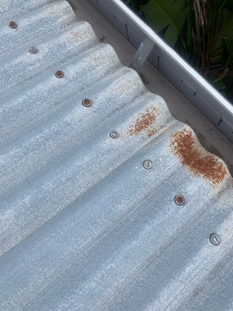 Close Up of Rust on Tin Roof — Top To Bottom Plumbing