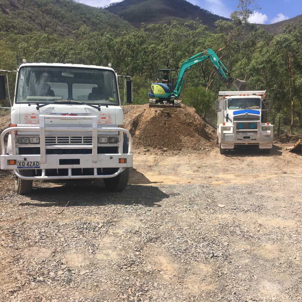 excavator loading the truck with gravel