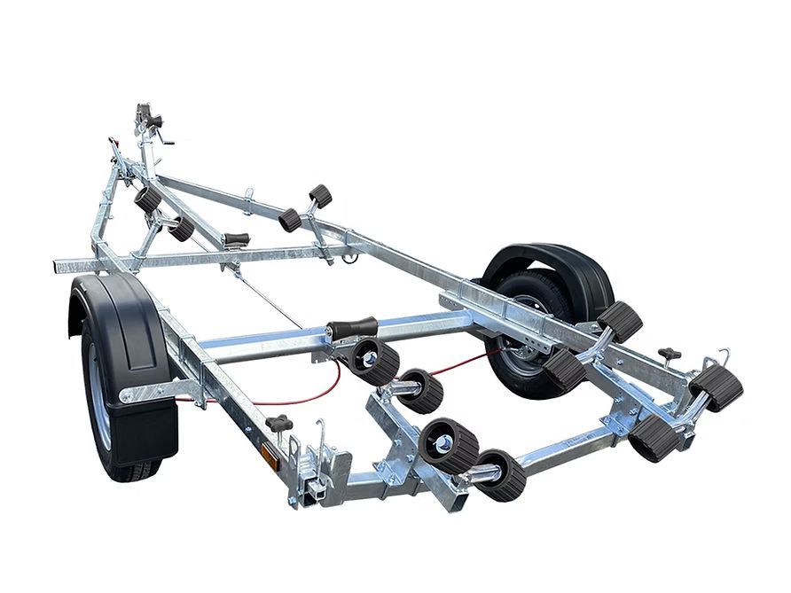 Silver boat trailer with black wheels and rollers on a white background.
