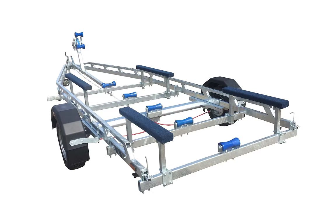 Boat trailer with galvanized steel frame and blue rollers, ready for transport.