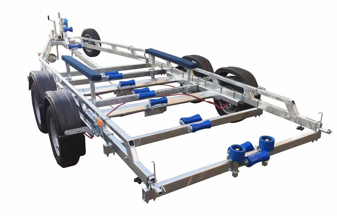 Boat trailer with blue rollers and supports on a metallic frame.