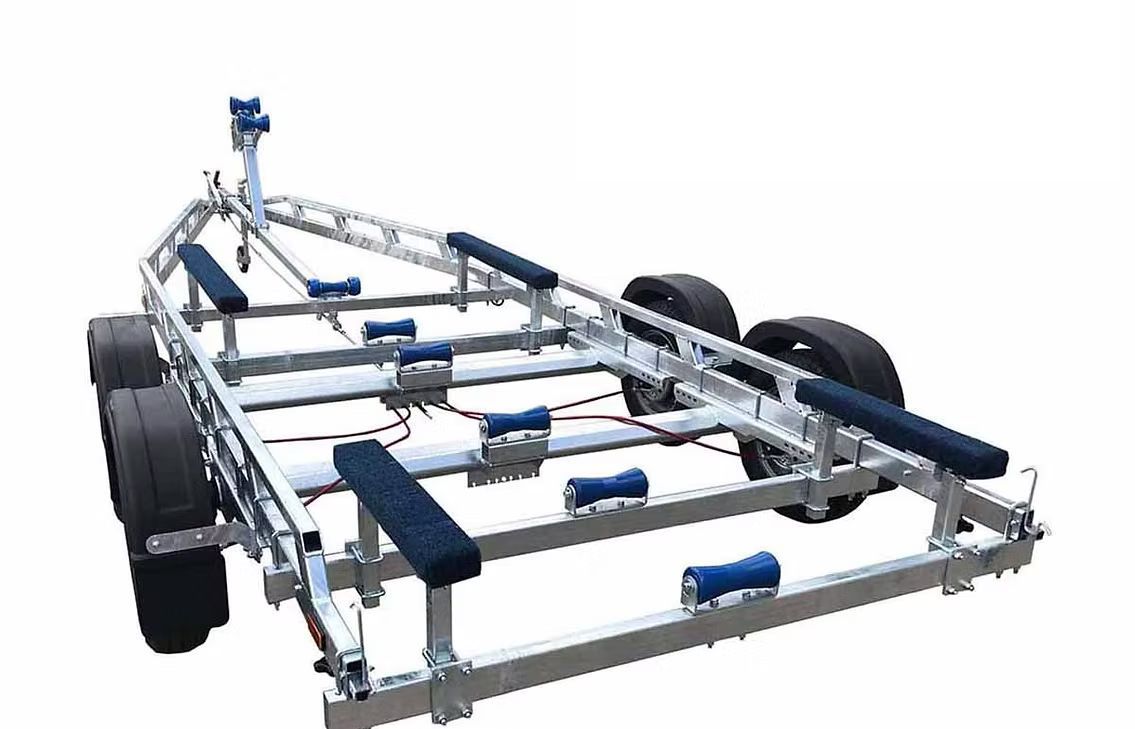 Boat trailer, silver frame, black tires, and blue rollers.