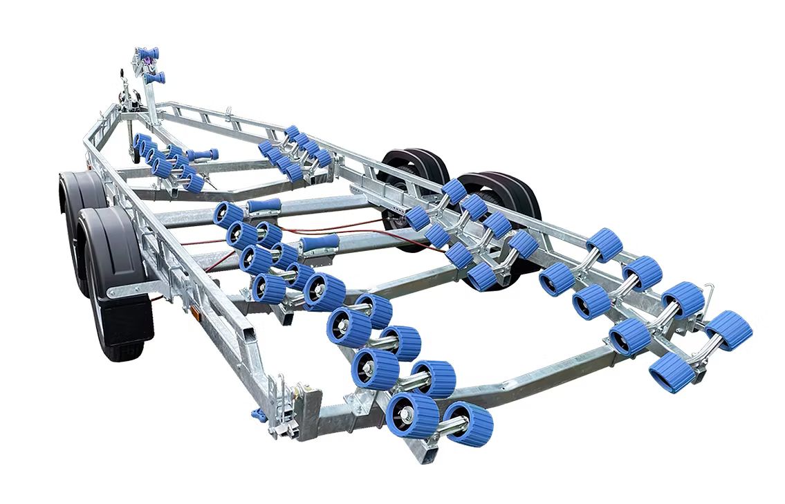 Boat trailer with numerous blue rollers and black tires.