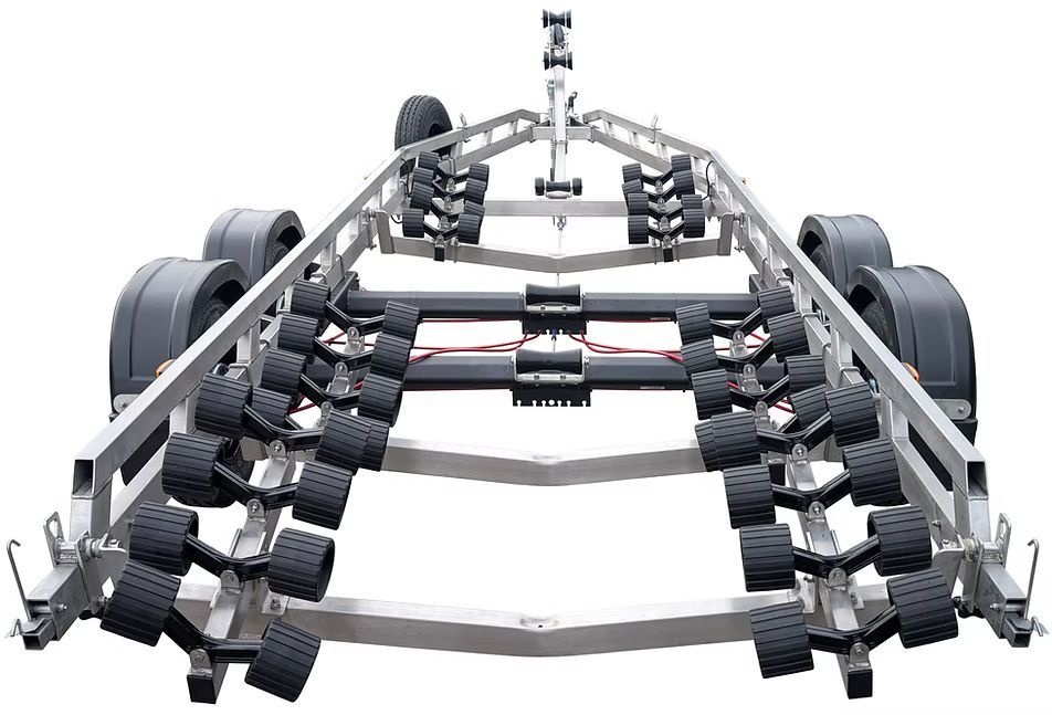 Silver boat trailer with rollers and winch, parked on pavement.