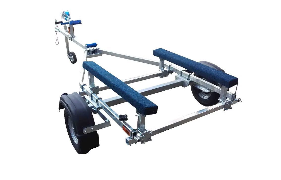 Boat trailer with blue padded supports and black tires.