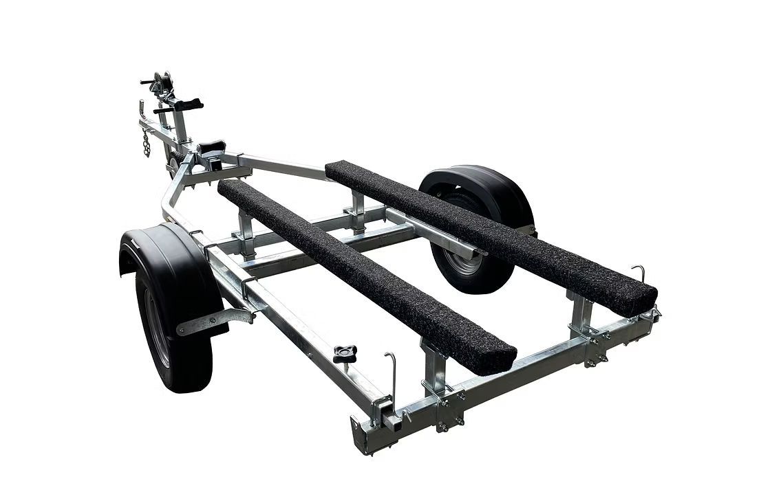 Boat trailer, metal frame with two black padded runners, single tire visible.