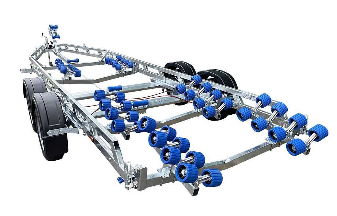 Boat trailer with numerous blue rollers and black tires.