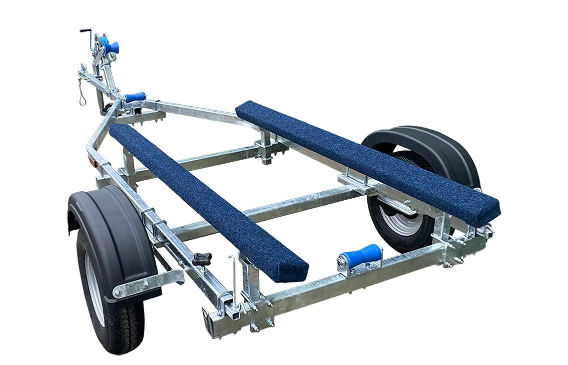 Galvanized boat trailer with blue carpeted bunks, black tires, and a winch.