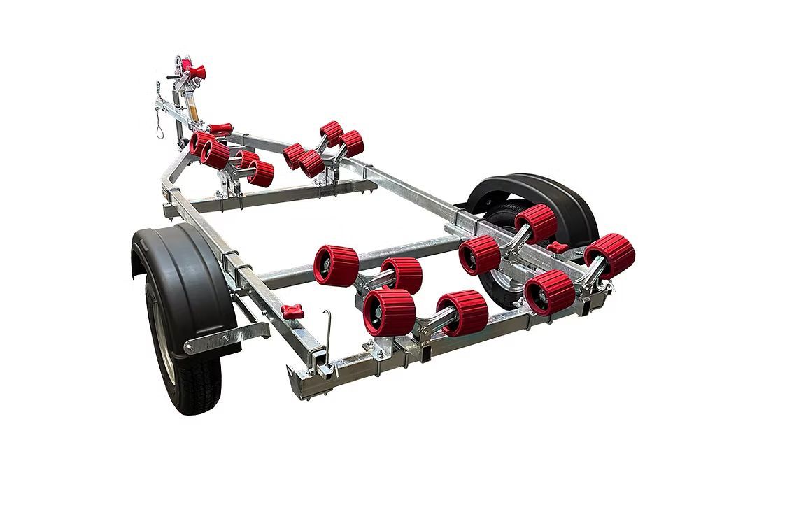 Boat trailer with red rollers and black tires.