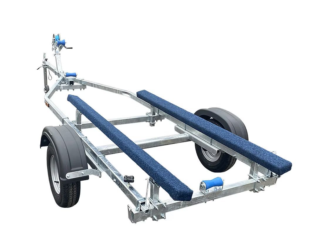Boat trailer with two blue carpeted bunks.