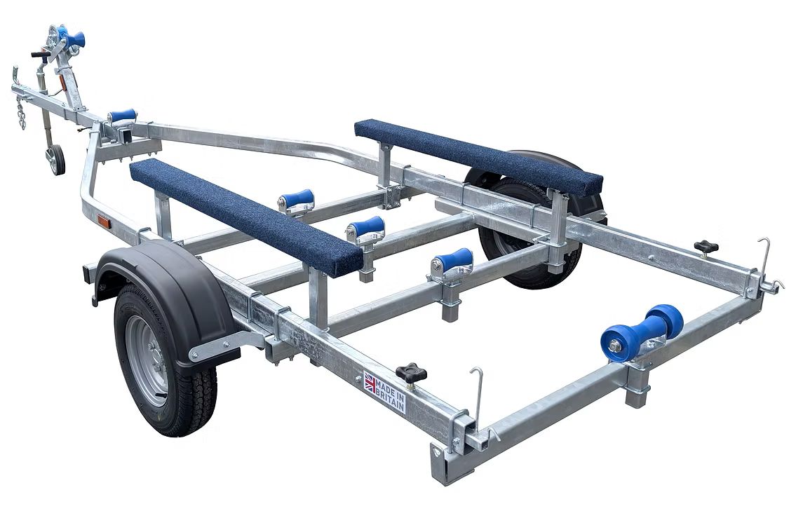 Boat trailer with silver frame, blue rollers and bunks, black tires.