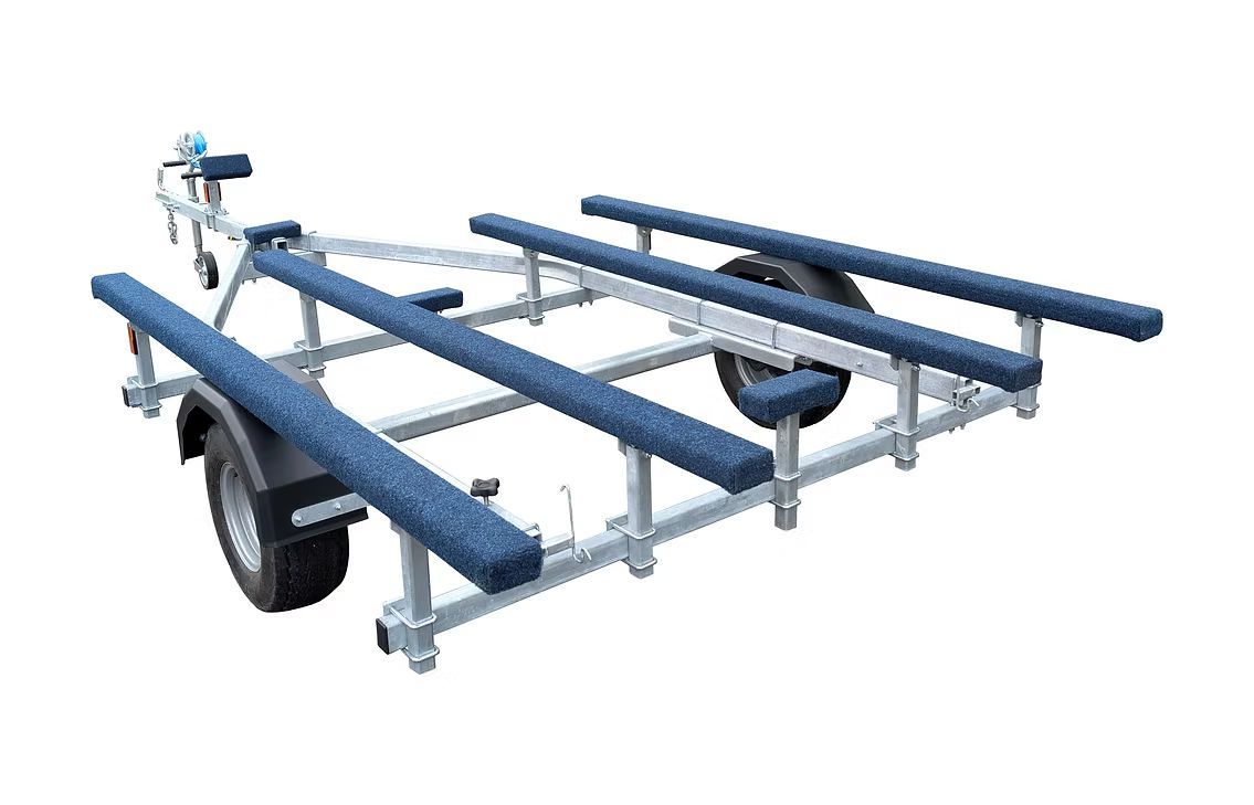 Boat trailer with blue padded rails, gray metal frame, and one black tire.