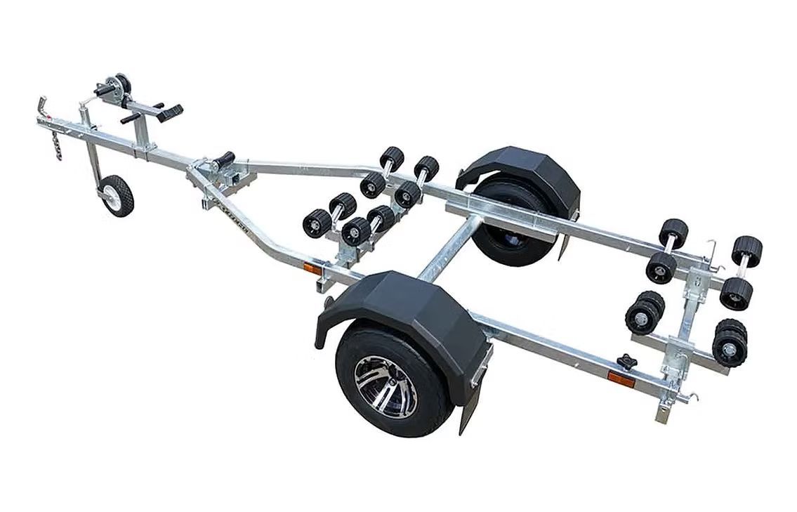 Boat trailer with multiple rollers, silver frame, black fenders, and wheels.