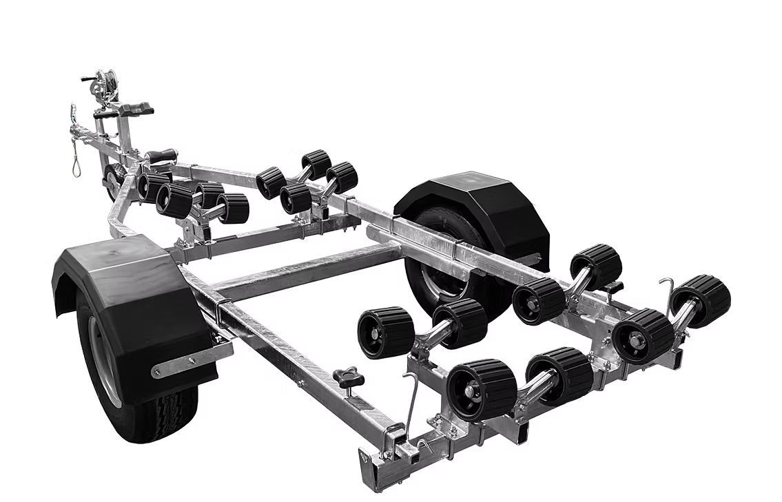Boat trailer with multiple black rollers and fenders, metal frame, set against a white background.