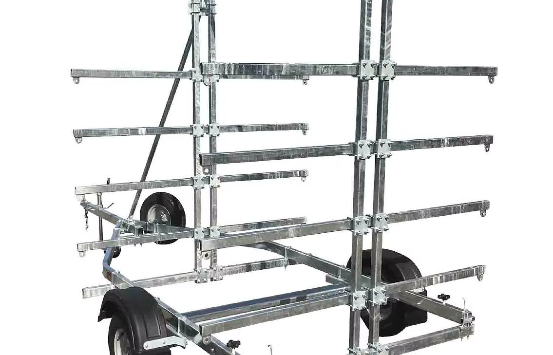 Metal kayak trailer with multiple horizontal supports for carrying watercraft.