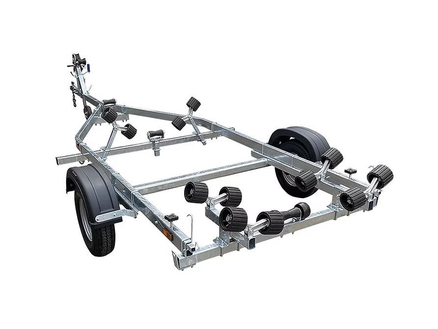 Boat trailer with multiple rollers, metallic frame, and black tires.
