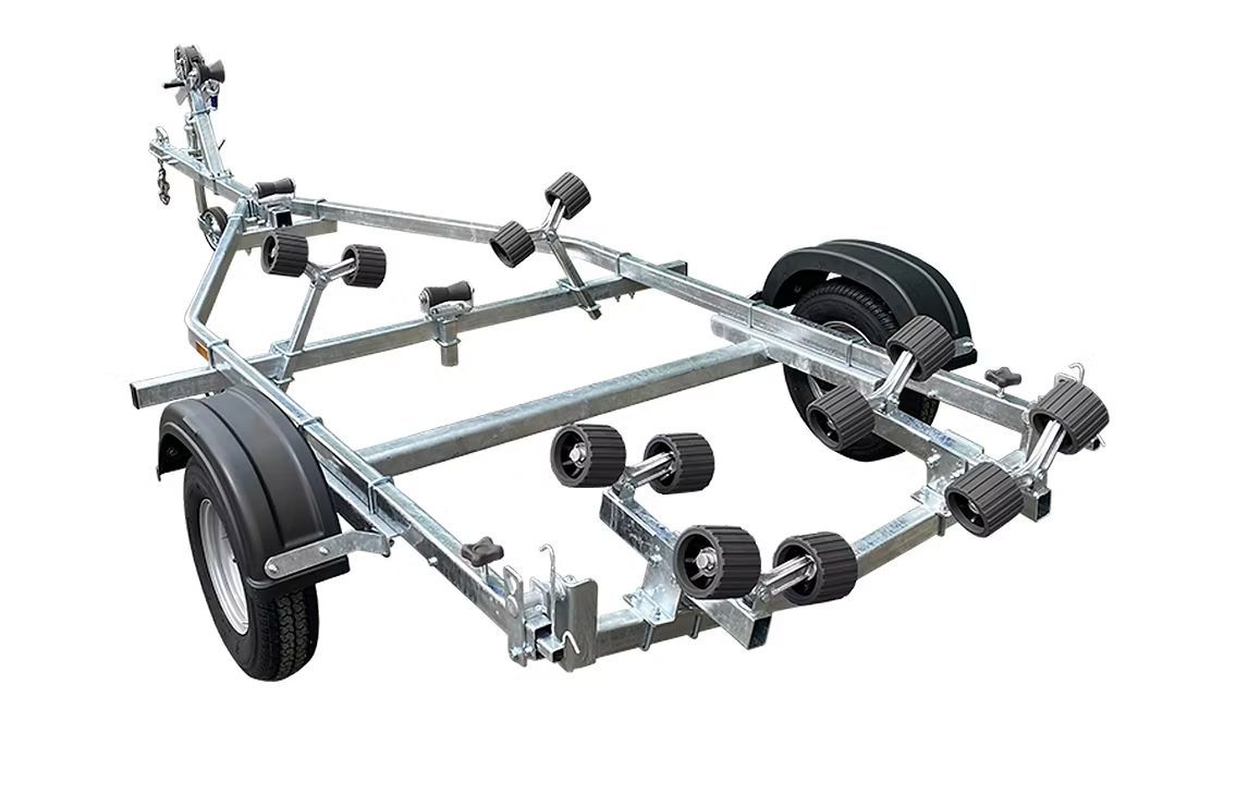 Boat trailer with numerous black rollers, metal frame, and wheels.