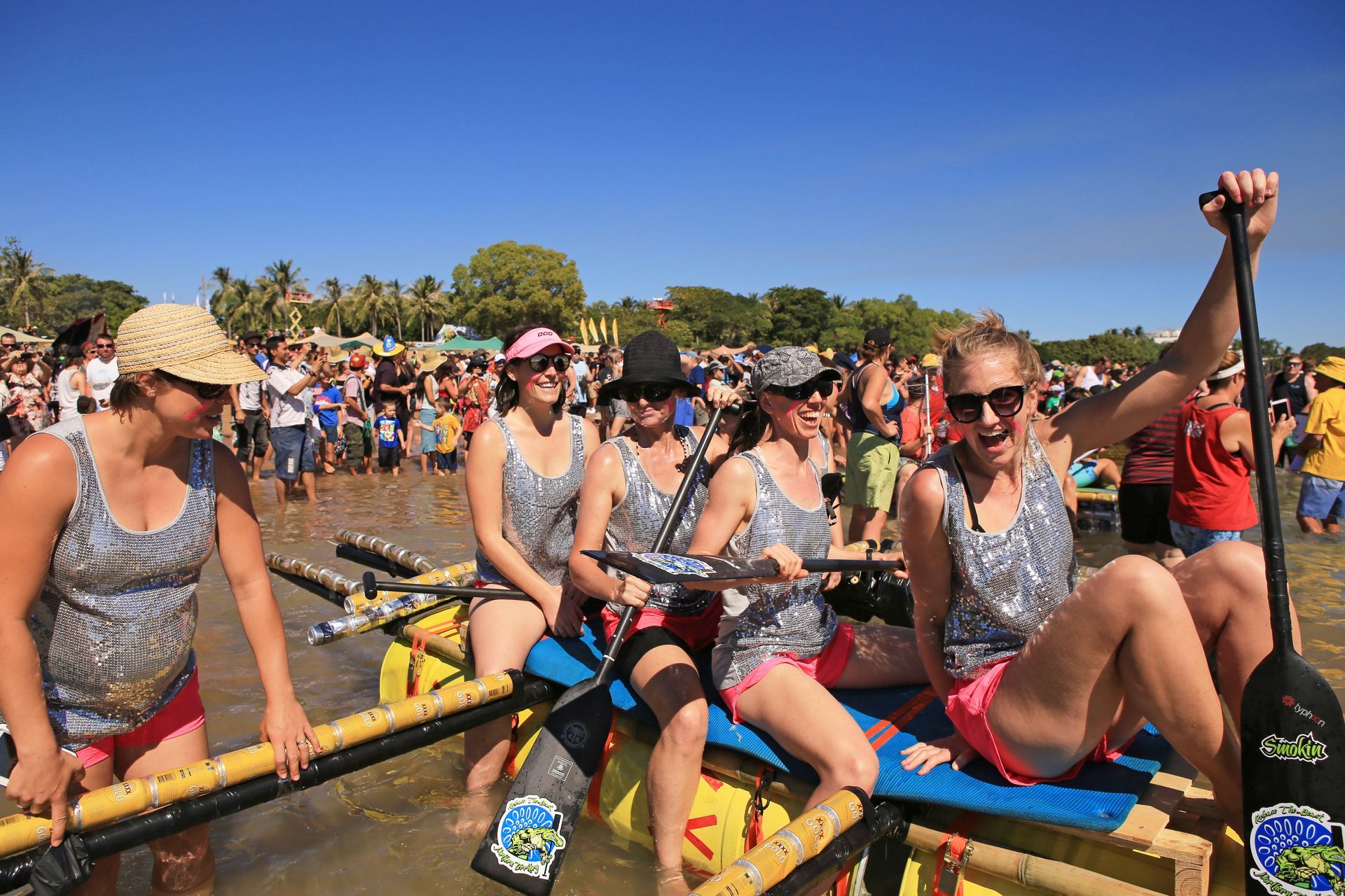A group of women are rowing a boat in the water.