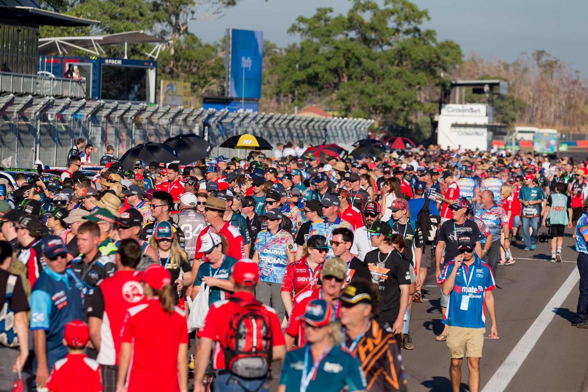 A large group of people are walking down a street.