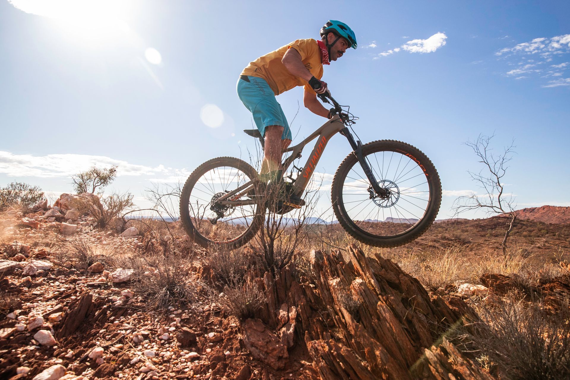 A man is riding a mountain bike on a rocky trail.