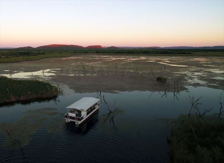 A boat is floating on top of a body of water.